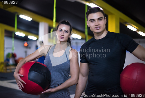 Image of young athletes couple working out with medical ball