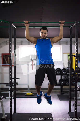 Image of man doing pull ups on the horizontal bar