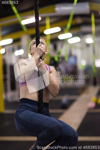 Image of woman doing rope climbing