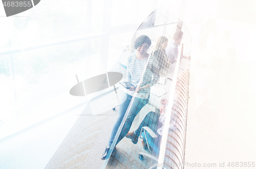 Image of Pretty Businesswomen Using Tablet In Office Building during conf