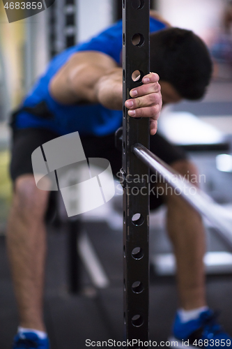 Image of man doing pull ups on the vertical bar