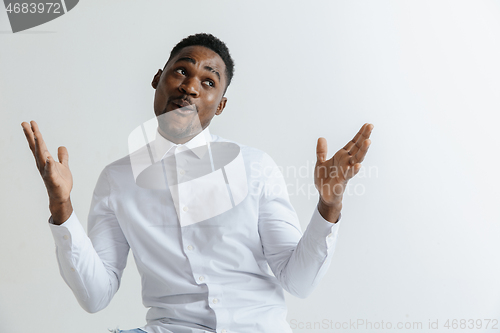 Image of Portrait of excited young African American male screaming in shock and amazement.