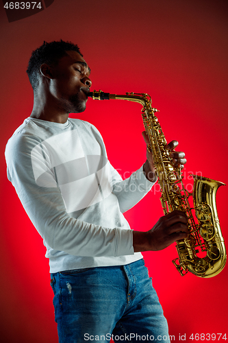 Image of African American jazz musician playing the saxophone.