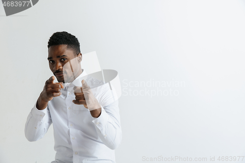 Image of Afro american man over isolated grey background pointing with finger to the camera and to you, hand sign, positive and confident gesture from the front