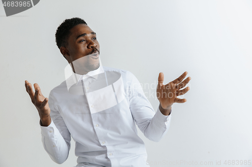 Image of Portrait of excited young African American male screaming in shock and amazement.