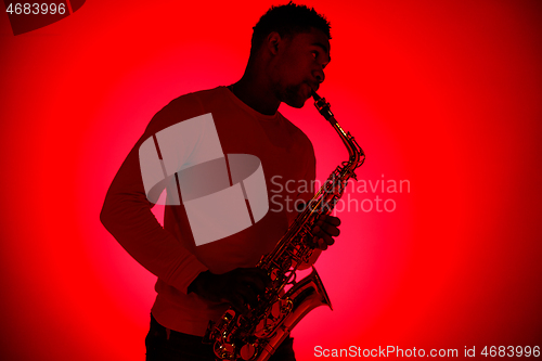 Image of African American jazz musician playing the saxophone.