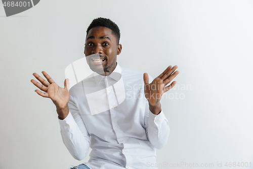 Image of Closeup portrait of handsome young man shocked surprised, open mouth and eyes, mad by what he sees, isolated on grey background. Negative human emotion facial expression feeling concept.