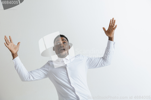 Image of Portrait of excited young African American male screaming in shock and amazement.