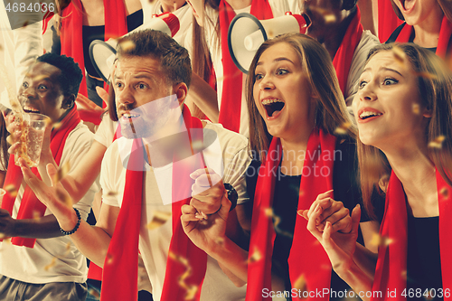 Image of Group of happy fans are cheering for their team victory.