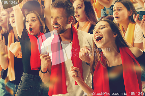 Image of Group of happy fans are cheering for their team victory.