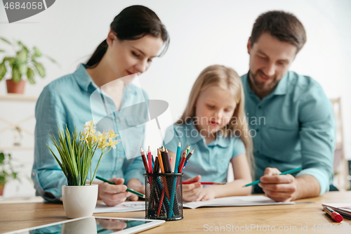 Image of Young happy family are spending time together. A day in lovely home.