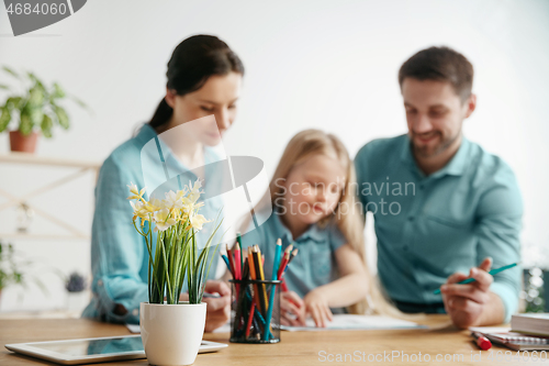 Image of Young happy family are spending time together. A day in lovely home.