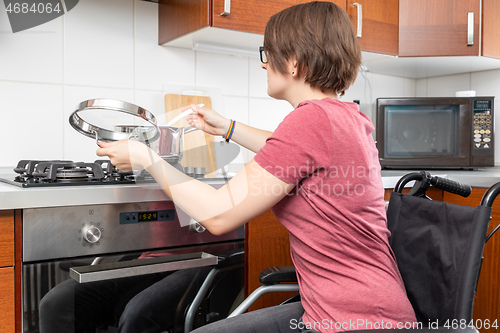 Image of disabled woman cooking in the kitchen