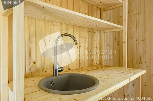 Image of Kitchen set in a country house, worktop and walls made of natural wood