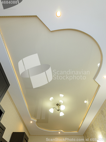 Image of Stretch ceiling with a golden tint with an original shape and design