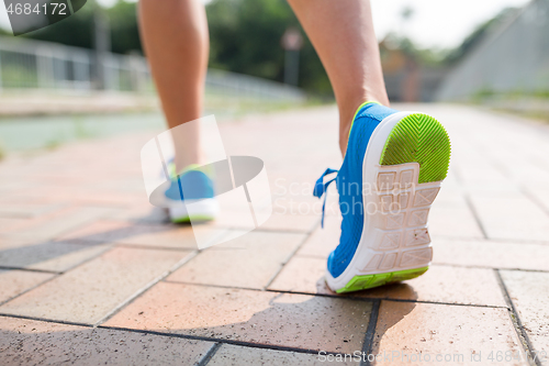 Image of Woman running in a city