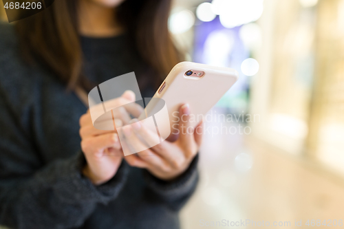 Image of Woman sending sms on mobile phone