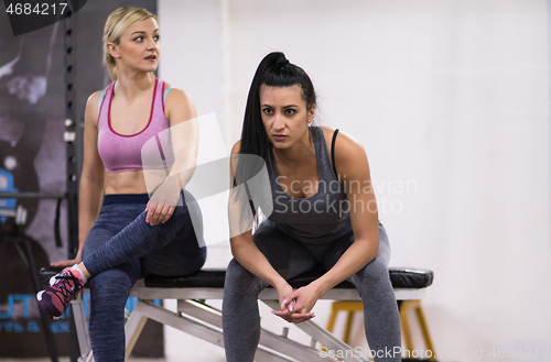 Image of young athletes women sitting and relaxing