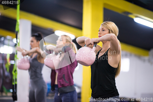 Image of athletes doing exercises with kettlebells