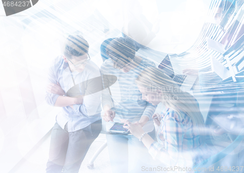 Image of group of Business People Working With Tablet in startup office