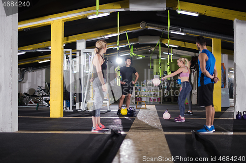 Image of athletes doing exercises with kettlebells