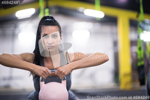 Image of woman exercise with fitness kettlebell