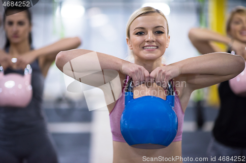 Image of athletes doing exercises with kettlebells