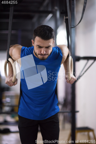 Image of man working out pull ups with gymnastic rings