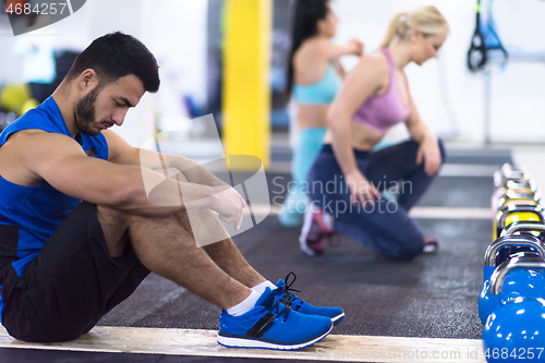 Image of young athletes doing pushups with kettlebells