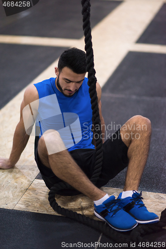 Image of man relaxing before rope climbing