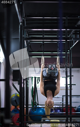 Image of woman working out on gymnastic rings