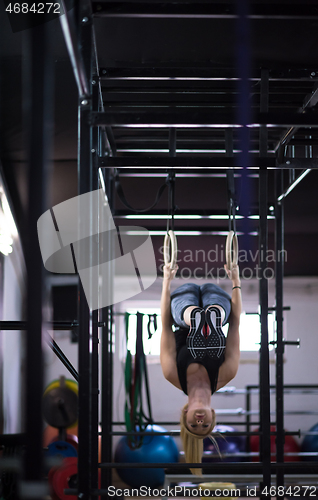 Image of woman working out on gymnastic rings