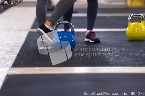 Image of athletes doing exercises with kettlebells