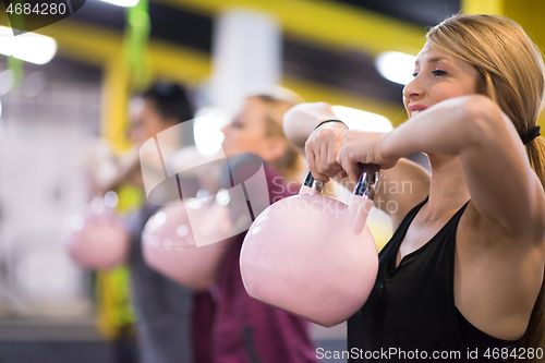 Image of athletes doing exercises with kettlebells