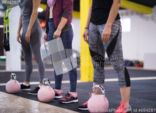 Image of athletes doing exercises with kettlebells