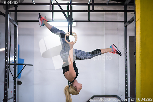 Image of woman working out on gymnastic rings
