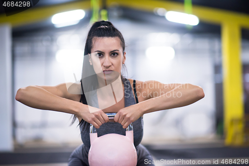 Image of woman exercise with fitness kettlebell