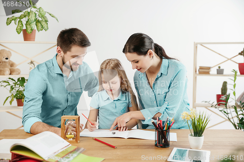 Image of Young happy family are spending time together. A day in lovely home.
