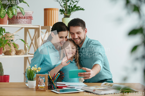 Image of Young happy family are spending time together. A day with loved ones at home.