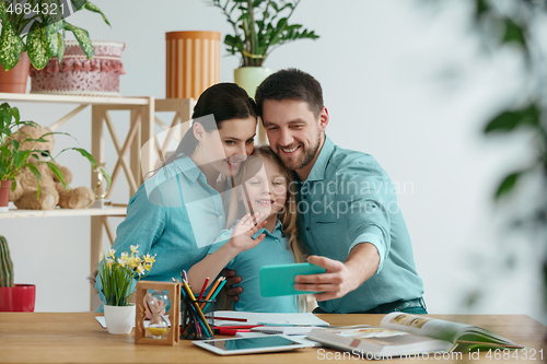 Image of Young happy family are spending time together. A day with loved ones at home.