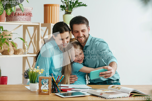 Image of Young happy family are spending time together. A day with loved ones at home.