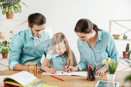 Image of Young happy family are spending time together. A day in lovely home.