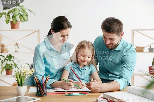 Image of Young happy family are spending time together. A day in lovely home.