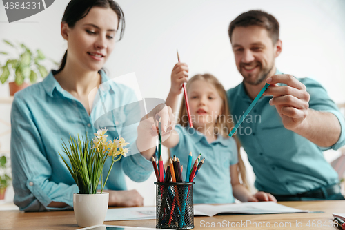 Image of Young happy family are spending time together. A day in lovely home.