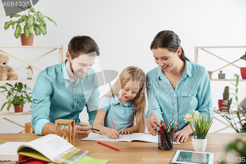 Image of Young happy family are spending time together. A day in lovely home.