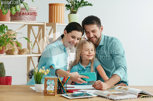 Image of Young happy family are spending time together. A day with loved ones at home.