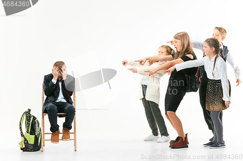 Image of Little boy sitting alone on chair and suffering an act of bullying.