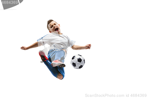 Image of Young boy kicks the soccer ball