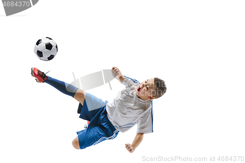 Image of Young boy kicks the soccer ball