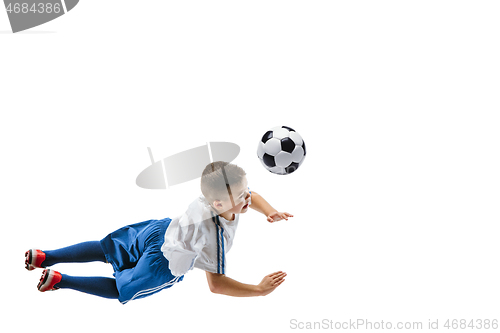 Image of Young boy kicks the soccer ball